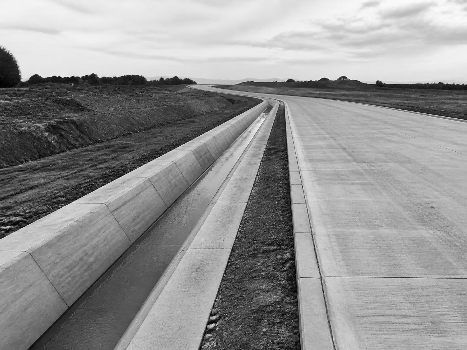 Newly constructed concrete carriageway and drainage channel